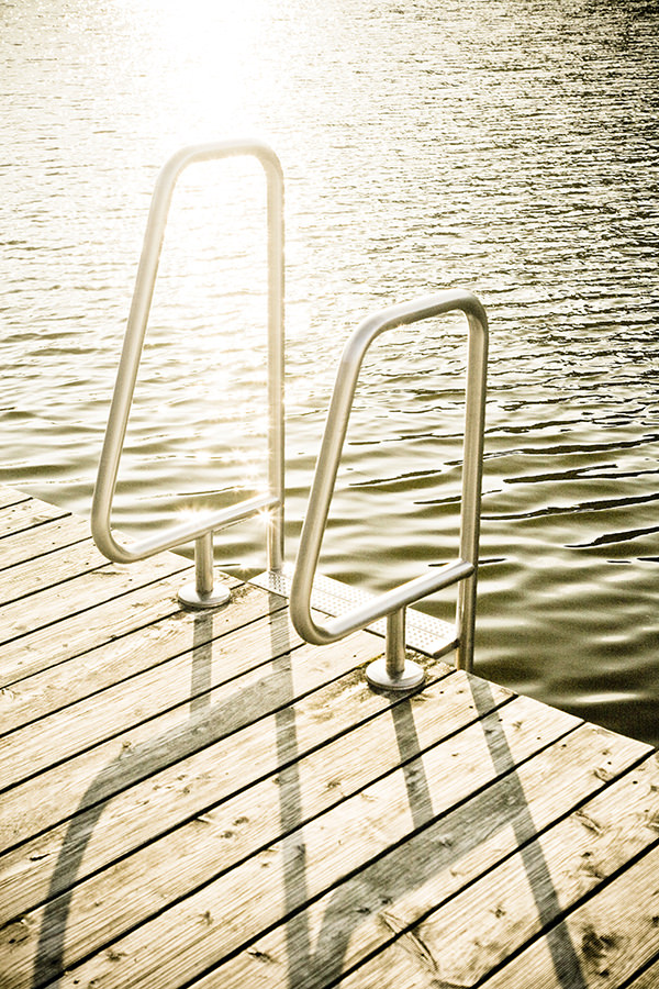 Picture of a deck with a ladder leading into lake